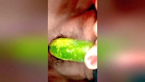 Indian housewife sucks a big cucumber in her mouth