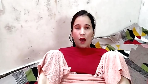 Indian schoolgirl in a school bathroom wears a dress and shorts