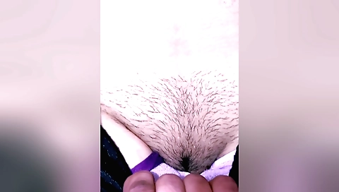 Indian hairy porn video shows a girl rubbing her pussy